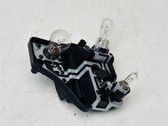 Tail light bulb cover holder
