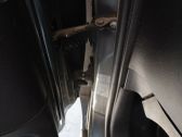 Front door check strap stopper