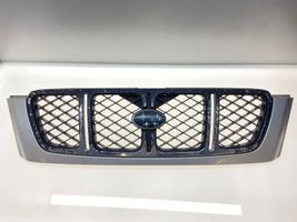 Subaru Forester SF Maskownica / Grill / Atrapa górna chłodnicy 91065FC