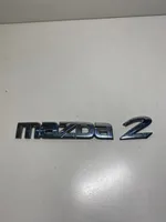 Mazda 2 Mostrina con logo/emblema della casa automobilistica D65251710