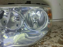 Chrysler Voyager Lampa przednia 084331105L