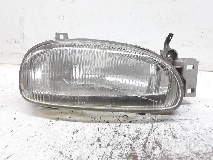 Mazda 121 Lampa przednia E20290061