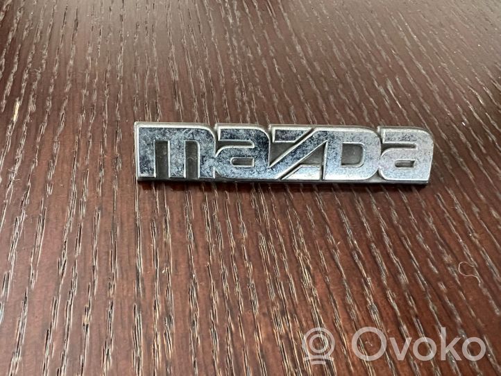 Mazda 323 Valmistajan merkki/logo/tunnus 
