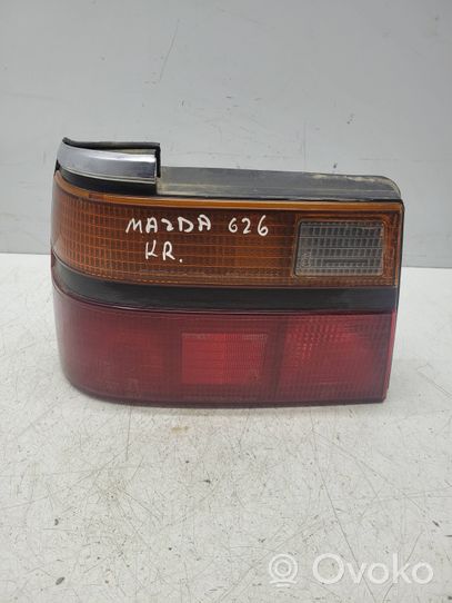 Mazda 626 Takavalon polttimon suojan pidike 0436888L