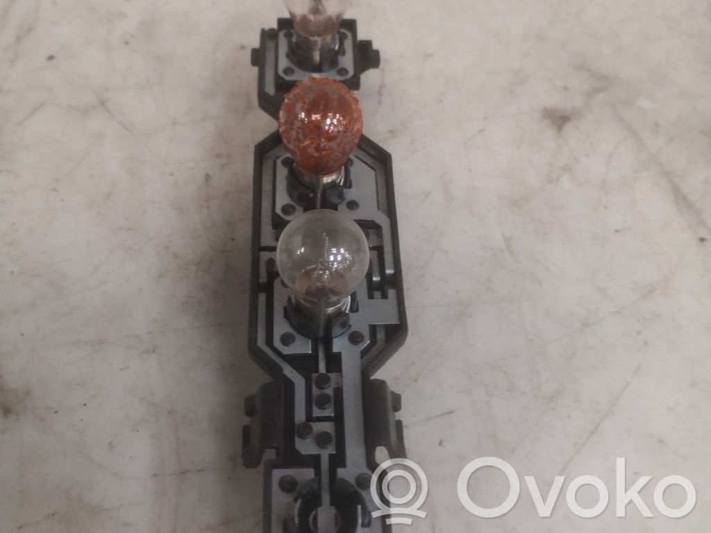 Tail light bulb cover holder