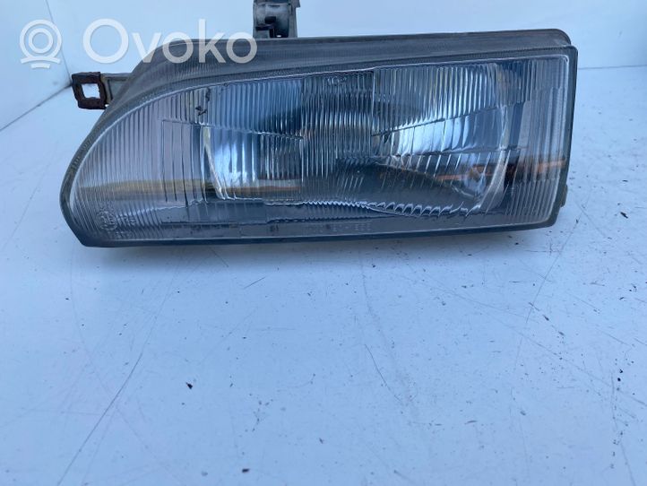 Toyota Corolla E90 Lampa przednia 201653B