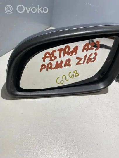 Opel Astra H Elektryczne lusterko boczne drzwi przednich E1010806