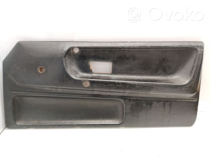 Volkswagen Polo II 86C 2F Front door card panel trim 867867022