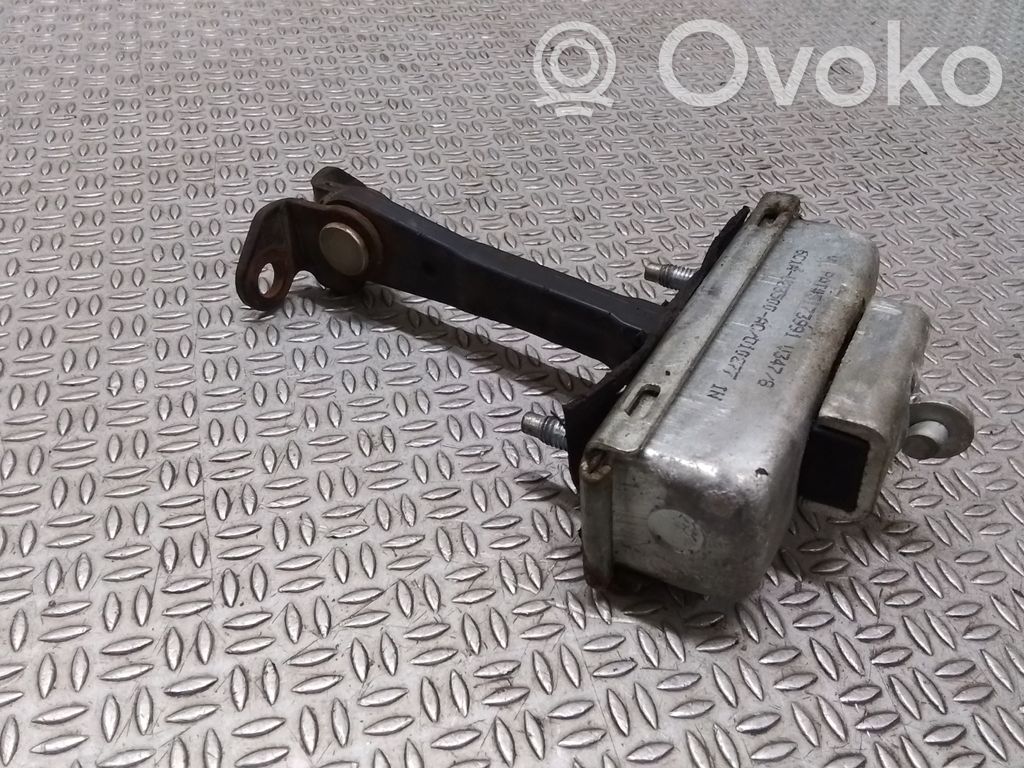 Front door check strap stopper