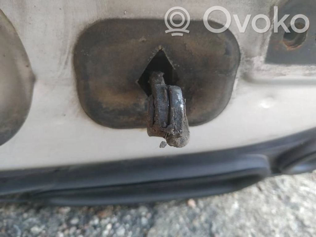 Front door check strap stopper